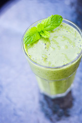 Healthy Paleo Vegan Green Smoothie with Banana, Spinach, Coconut Oil and Almond Milk, Vertical View