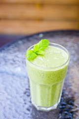 Healthy Paleo Vegan Raw Green Mint Smoothie on the Table, Vertical View