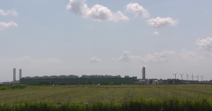 MIDDENMEER, THE NETHERLANDS - JULY 2017: datacenter Microsoft in Dutch polder landscape, Noord Holland. Wind turbines at horizon.