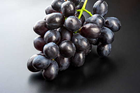 Bunch of black grape isolated on black background