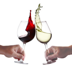 Two Hands holding glasses of red and white wine with splash