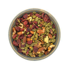 Top view of Omega 3 trail mix in an old stoneware bowl isolated on a white background.