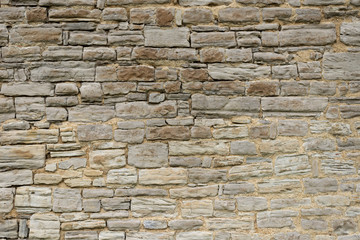 Background texture of a stone wall from an old gray stone