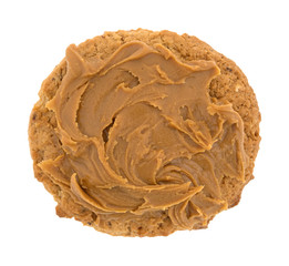 Top view of an oatmeal cookie with cookie butter topping isolated on a white background.