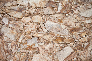 Close-up of colorful old stone wall texture, background. Stone fences. Stone wall pattern natural surface, decoration texture. Modern and creative interior and exterior walls design. 