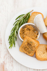toasts with fish pate on white plate