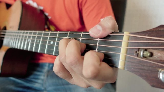 man playing acoustic guitar close up shot