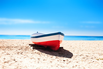 Catalonia, Spain - July 24, 2017: Beach sand, sea and boats in Badalona,  View of the beach with colorful art fishing boats.