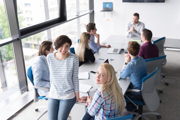 Pretty Businesswomen Using Tablet In Office Building during conference