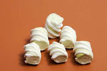 Pile of marshmallows glazed . Many coated elegant zephyr dessert isolated on white. Sweet elegant dessert on a plate