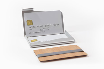 Metal and wooden business card holders with white credit cards