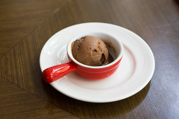 Chocolate ice cream in red cup.