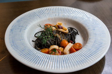 Italian black spaghetti with seafood and tomato, selective focus