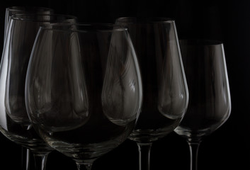 Set of high wine glasses on black close up
