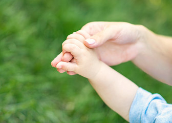 Mother holding hand of a small child