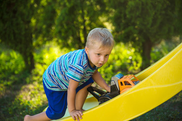 A boy on the play ground. Children slide