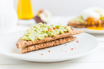 Wholemeal Bread Toast and Poached Egg with mashed avocado and ch