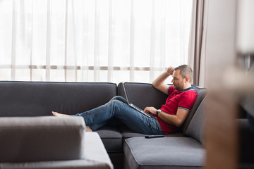 Man using laptop in living room