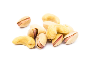 Pile of roasted pistachios isolated on white background