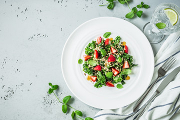 Salad with kale, strawberries, quinoa and mint leaves