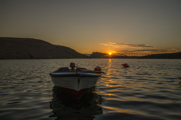 Fototapeta na wymiar Boat on the Adriatic sea with Krk bridge on the background / Croatia