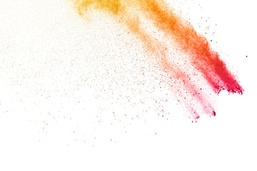 The explosion of colored powder. Beautiful powder fly away. The cloud of glowing color powder on white background