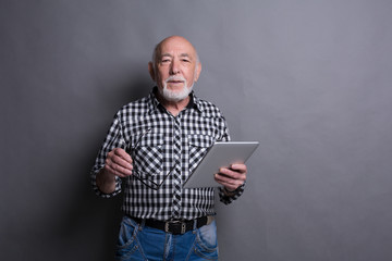 Senior man with digital tablet portrait