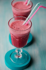 Fresh cool smoothie in a glass with a stem. Delicious and healthy Breakfast. Of cherries and strawberries