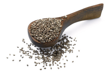 Chia seeds in the wooden shovel, isolated on white