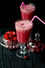 Fresh cool smoothie in a glass with a stem. Delicious and healthy Breakfast. Of cherries and strawberries