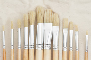 Set a paint brush on a canvas holder