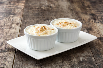 Arroz con leche. Rice pudding with cinnamon on wooden background

