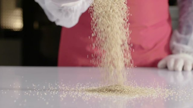 bulgur wheat falling into a white kitchen table. super slow