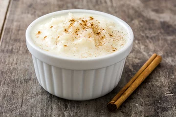 Foto op Canvas Arroz con leche. Rice pudding with cinnamon on wooden background     © chandlervid85