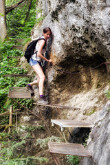 Naklejka na ściany i meble Trekking woman in climbing trail
