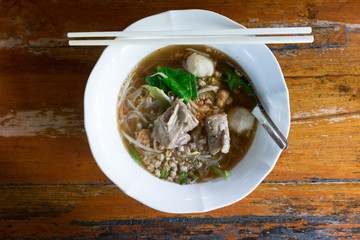 Spicy TOM YAM pork noodle soup with lemongrass, chilly pasted and lime juice.