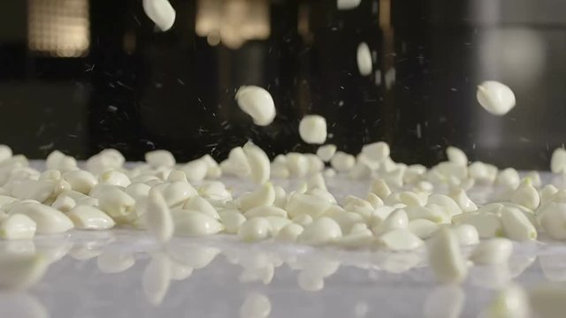 Clove of garlic drop off wet benchtop. Super slow