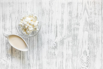 Farm dairy products. Milk and cottage on light wooden background top view copyspace