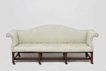 Green antique settee with brass studs