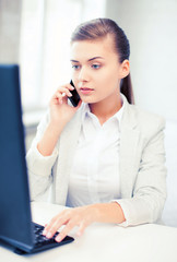 businesswoman with smartphone in office