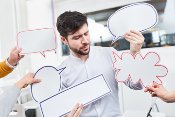 Mann mit Sprechblasen für Ideen und Diskussion