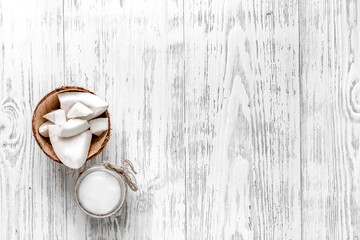 Organic cosmetics with coconut. Coconut oil on wooden background top view copyspace
