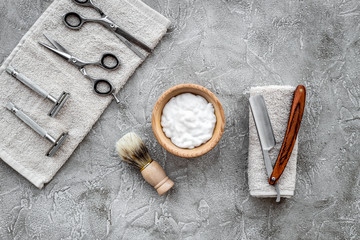 Preparing for men shaving. Shaving brush, razor, foam, sciccors on grey stone table background top view copyspace