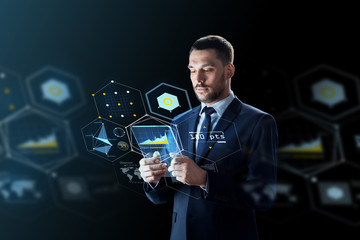 businessman with tablet pc and virtual projections