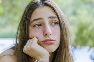 Beautiful teenager worried on her holidays, after bathing in the pool.