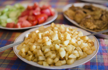 Colorful lunch, french fries, cucumber, tomato, chicken