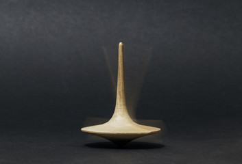 Spinning top on dark background