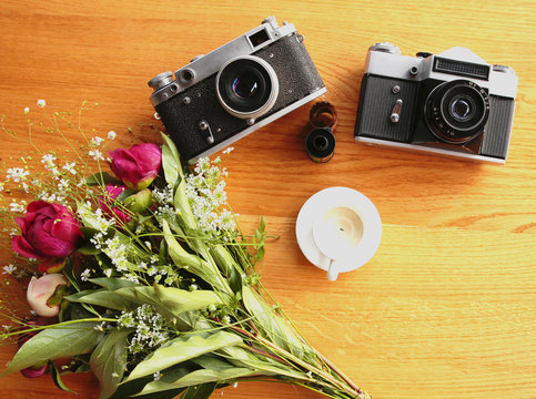 vintage camera near a bouquet of flowers and candles