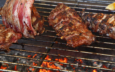 Racks of pork spare ribs on fire barbecue grill