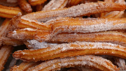 Sweet fresh churros snack with sugar close up